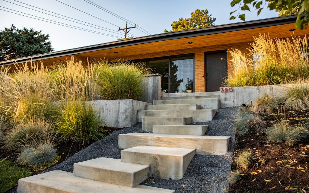 But hardscaping is more than just rocks, too. It involves things like cement pool decks, brick patios, stone retaining walls, gravel walkways, iron arbors, and even wooden benches