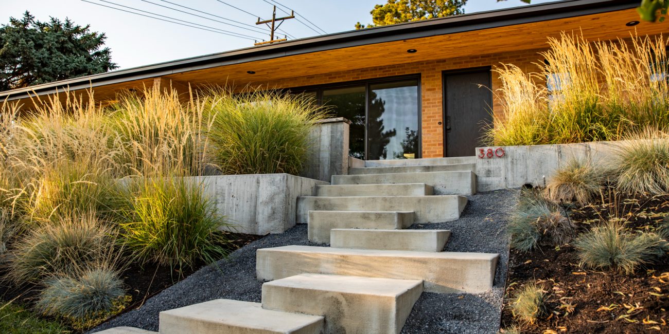 But hardscaping is more than just rocks, too. It involves things like cement pool decks, brick patios, stone retaining walls, gravel walkways, iron arbors, and even wooden benches