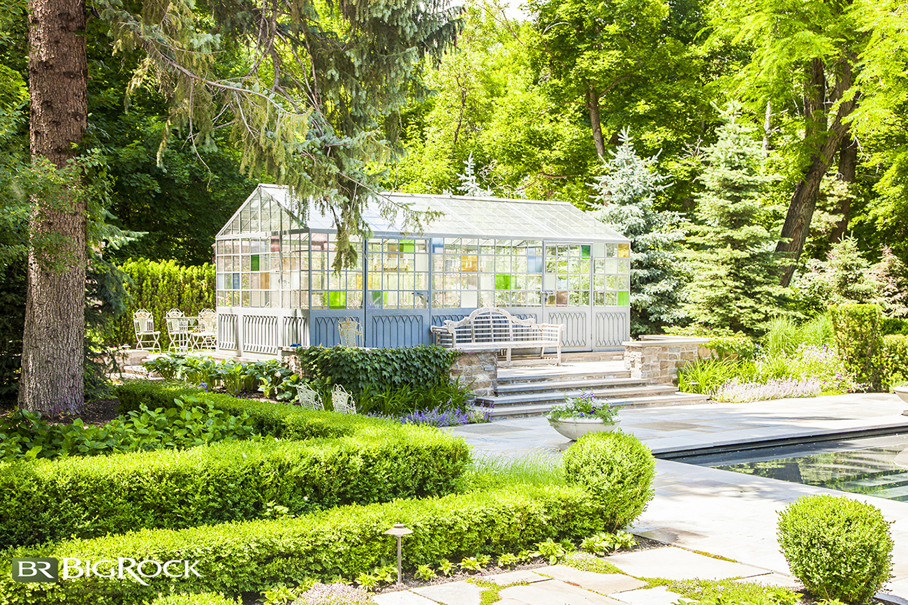 Large structures such as greenhouses can add a special touch to your landscape. Use masonry, stairs, and landscape bushes to enhance structures within your residential landscaping.