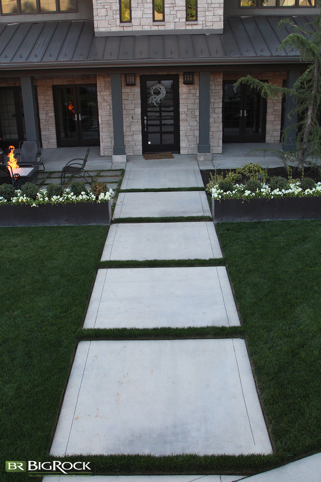 Break up large cement walkways with grass, shrubs or moss for interesting design elements in your home landscaping.