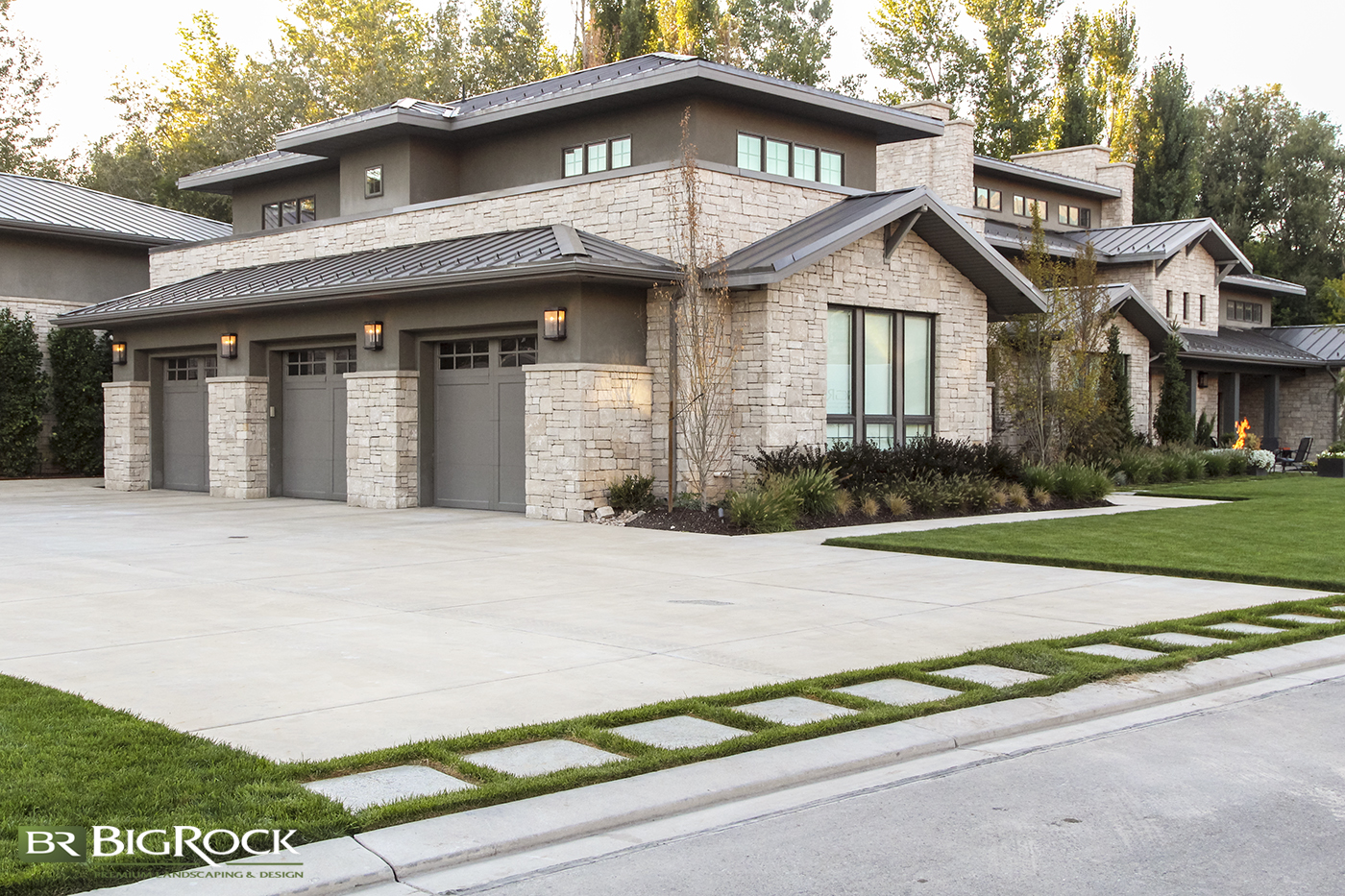 A driveway doesn't have to be boring and solid cement. Create a functional entrance into your driveway with pavers and grass that is unique and interesting for your landscape.