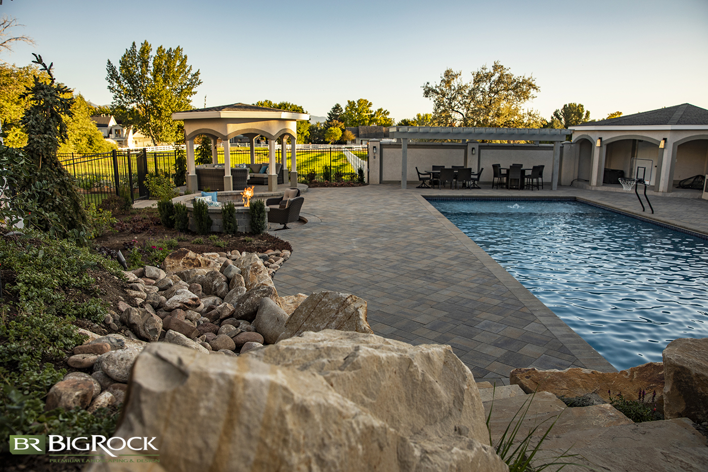 Adding recreation to your backyard landscaping design doesn't have to be ugly and the focal point. Hide your pool slide among natural rock and stairs for a natural design.