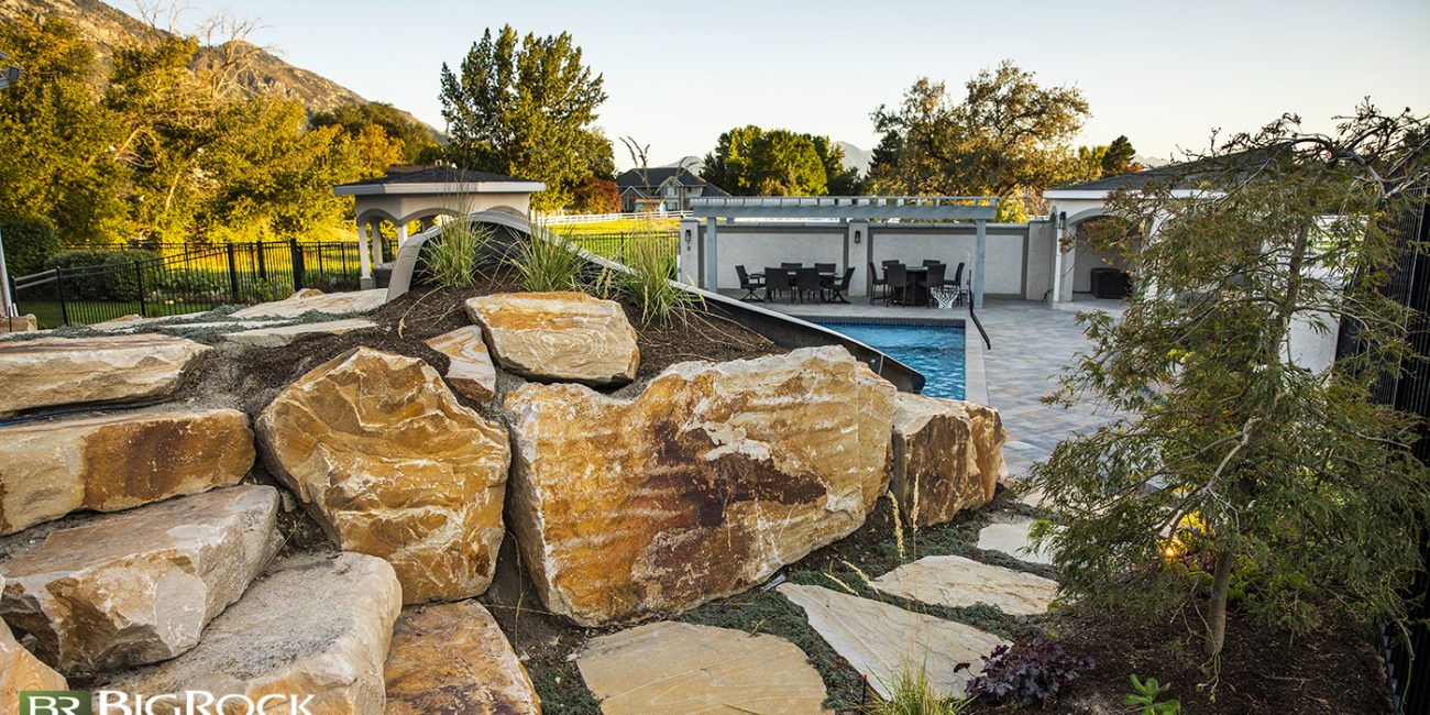 rock landscaping in backyard with pool
