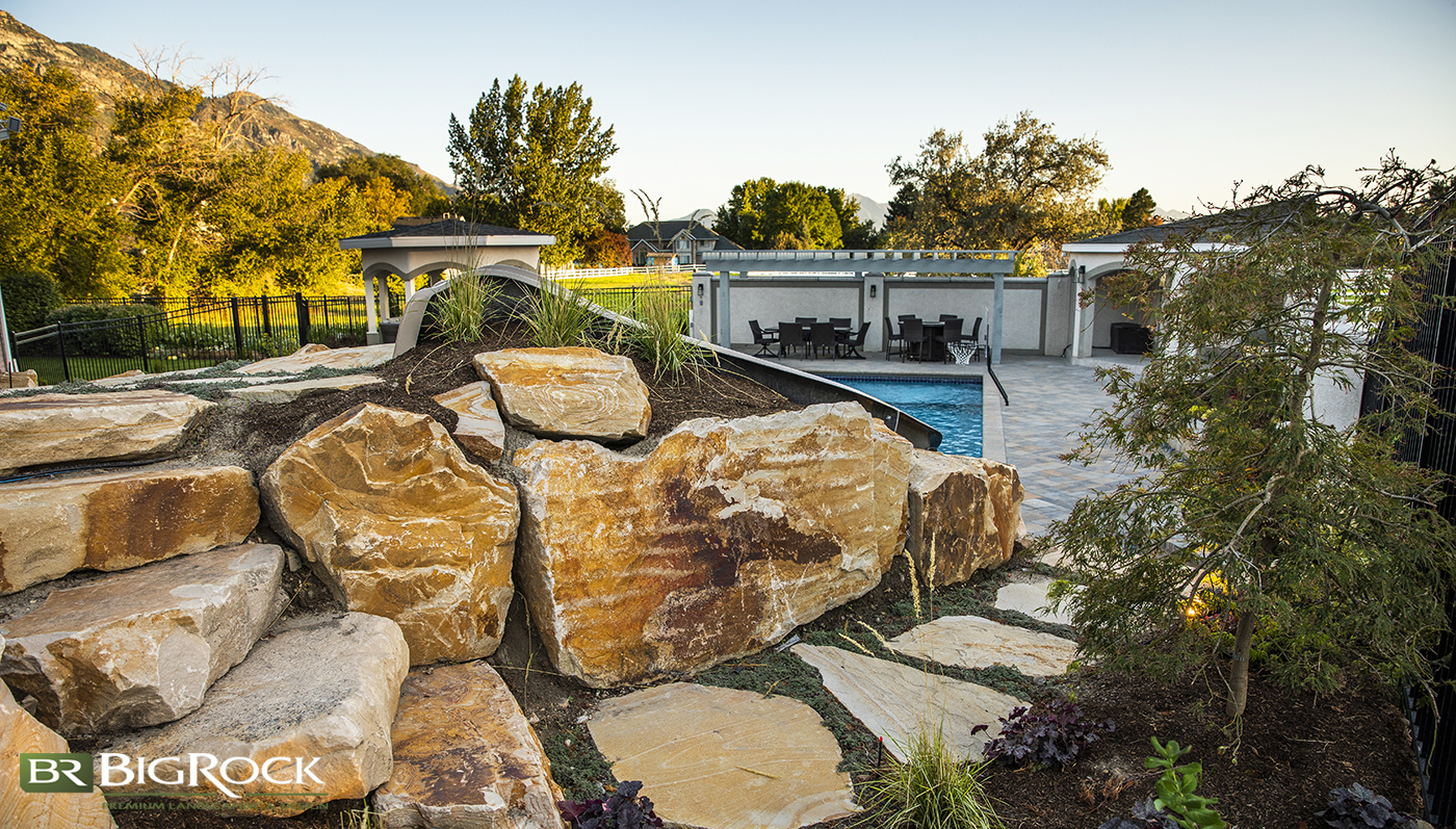 rock landscaping in backyard with pool