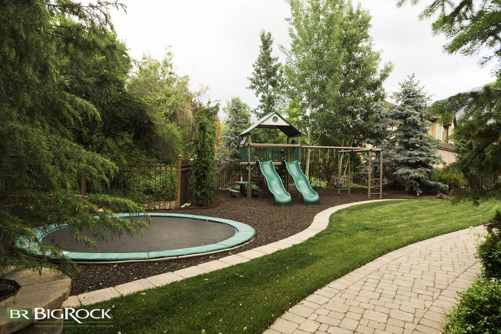 This yard does an incredible job of incorporating greenery around the recreational elements, giving it a park-like appearance.