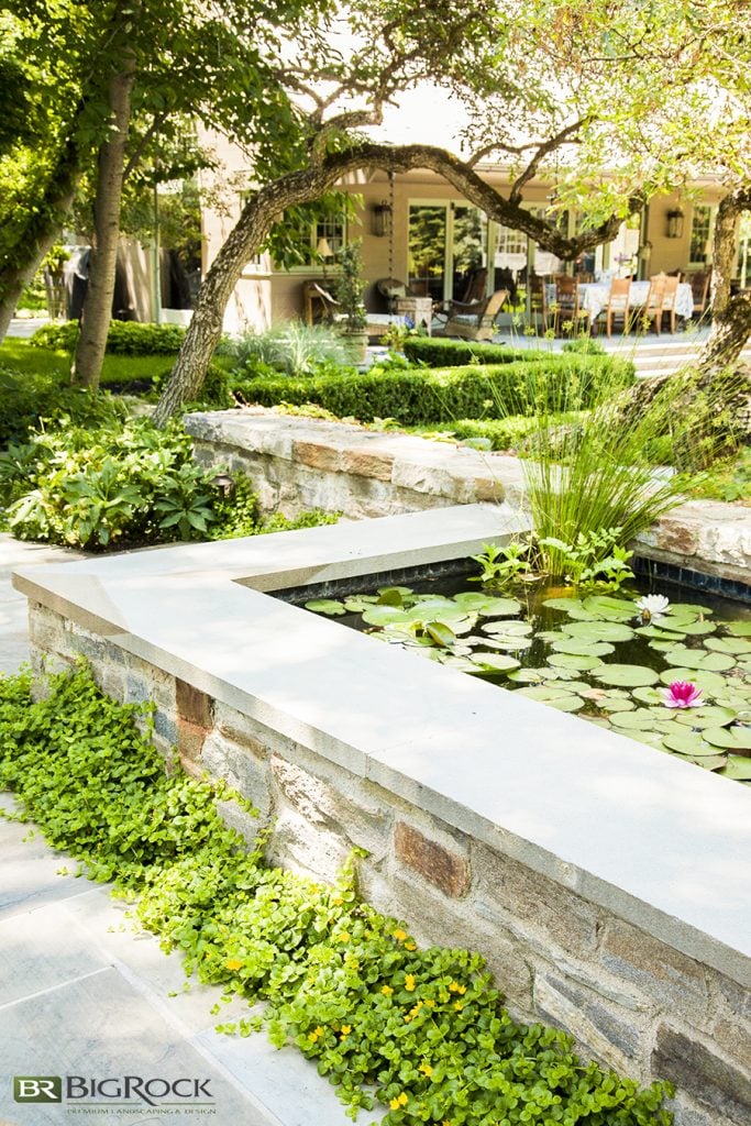 raised backyard pond with rock wall