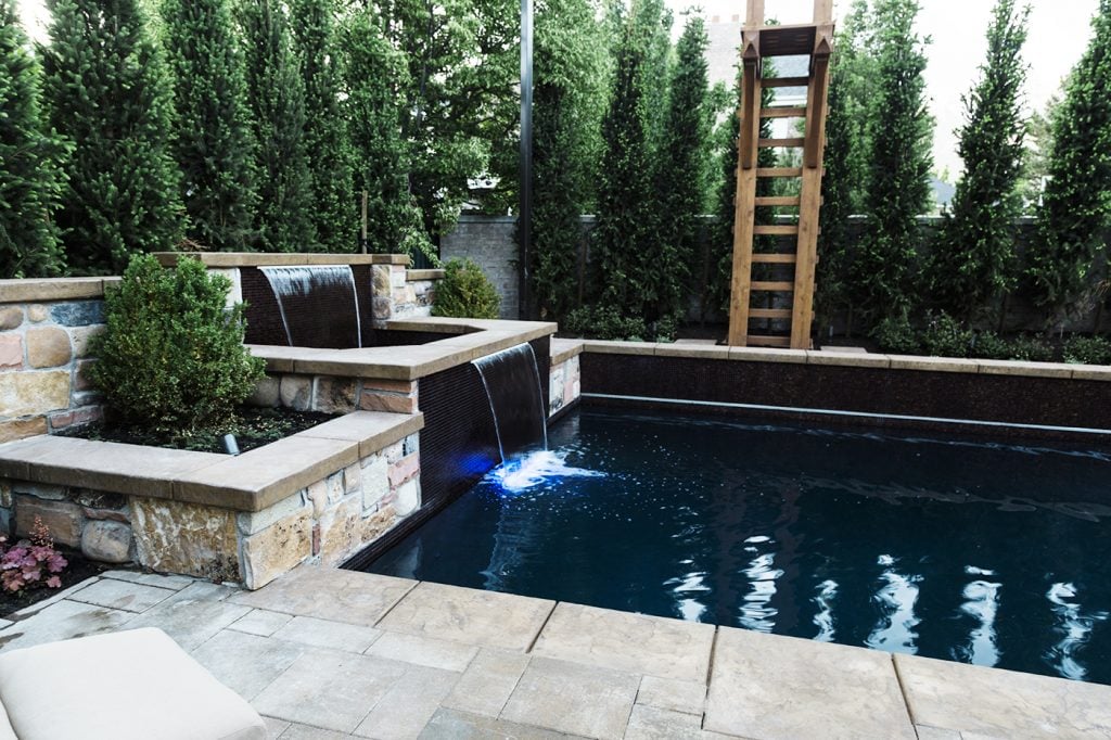 natural stone flower beds around pool