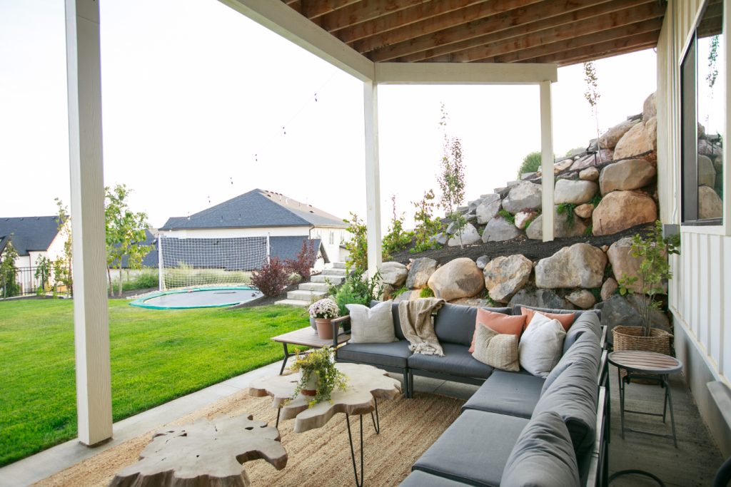 The bottom patio has even more outdoor seating and entertainment space. String lights, an inviting outdoor sectional, and great views are the epitome of outdoor entertainment.