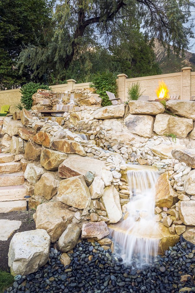 This waterfall into a pool offers not only looks incredible but adds fun to the pool for kids and adults alike!