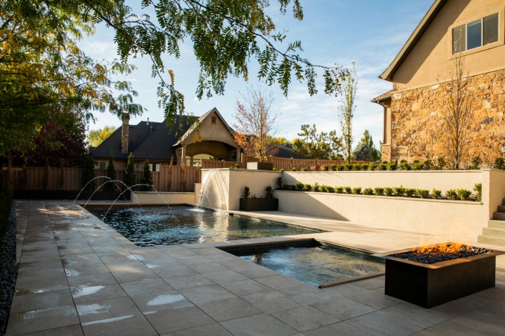 The clean lines offered from the hardscaping to create a space for the softness of the shrubs, as well as the water features and the fire make this pool one you won’t want to leave