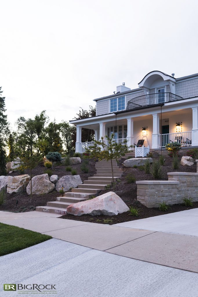 Your front landscape isn’t just about what you plant. Your pathways, borders, pots, porch, and other hardscape elements come into play as well.