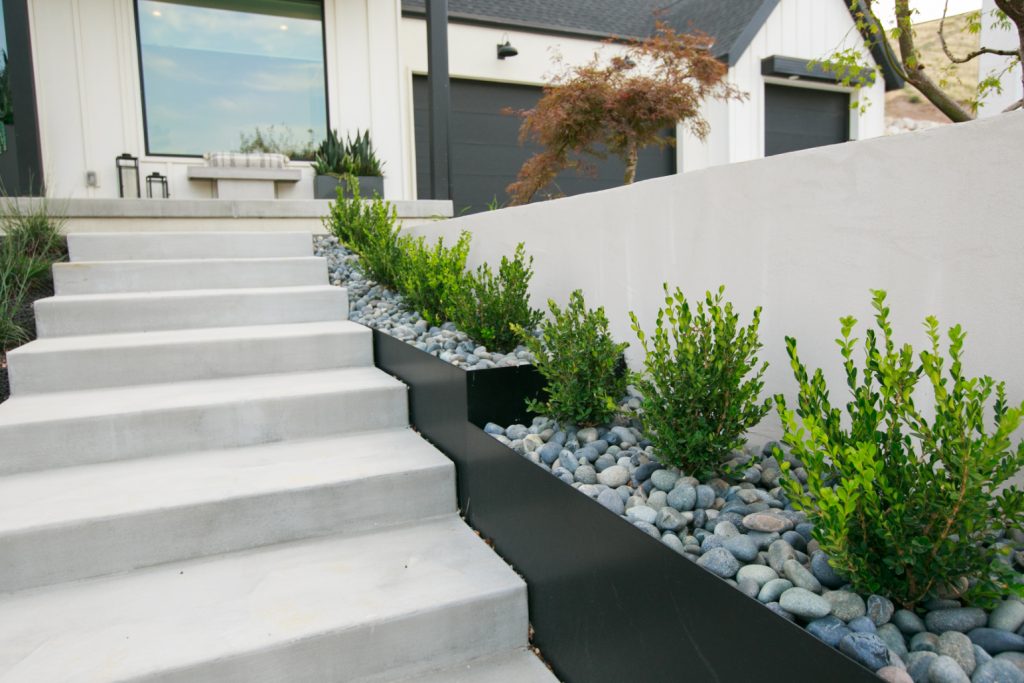 The clean lines and neutral colors give contemporary vibes while adding green to the walkway.