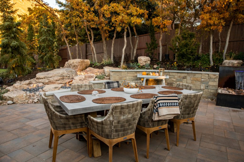 We added more trees, a water feature, a large patio, and a fire feature that cascades through the rocks. We can help you dream BIG