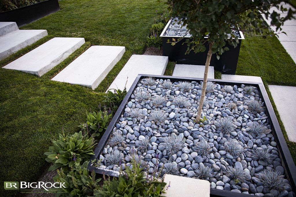 Surrounding your plantings with rocks in your planters and garden beds can help them retain moisture while adding a unique visual element too.