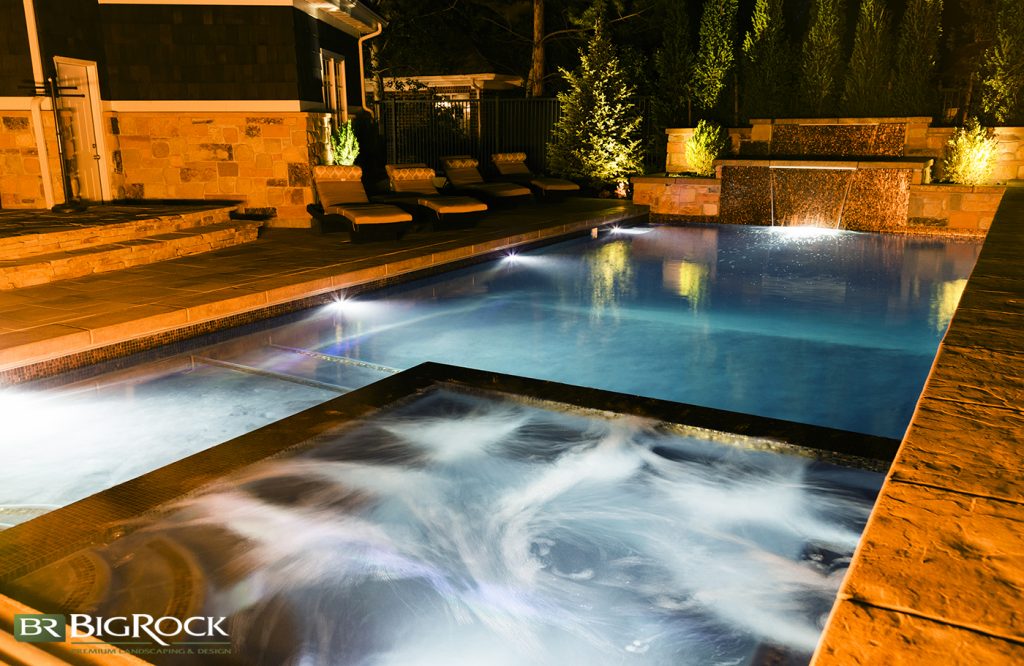 In this picture, lighting has been carefully installed around the pool edge and in the spa so that this space is visually defined even in low lighting