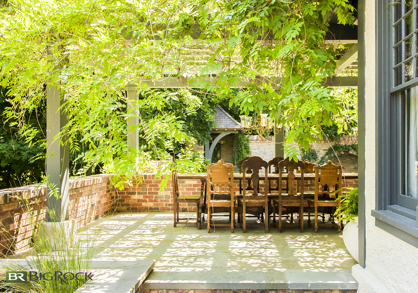 Use trailing plants above your pergola to create a natural canopy and shady environment on your backyard patio.