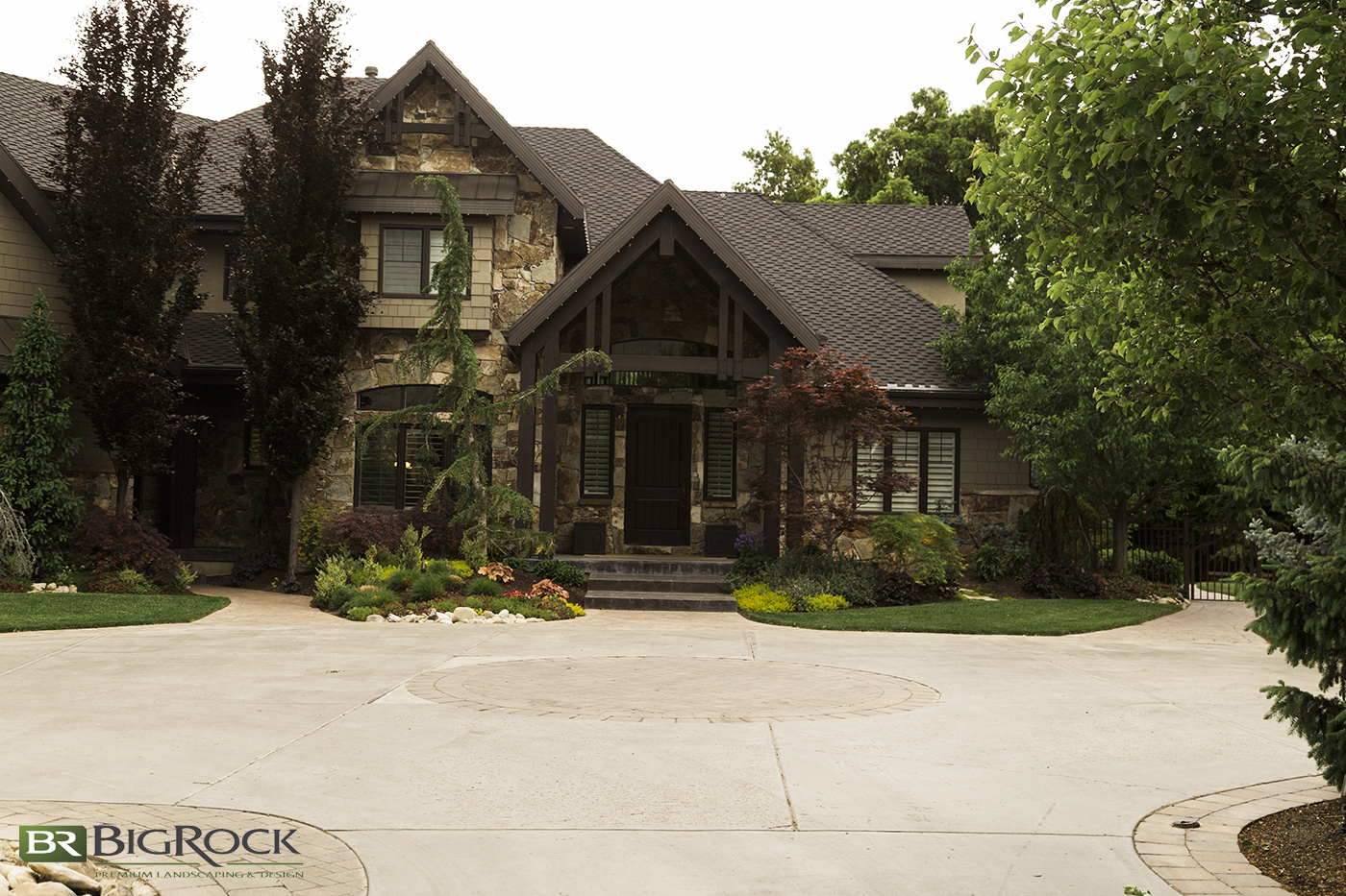 Add beautiful stone work and designs to large cement areas for landscaping design interest.