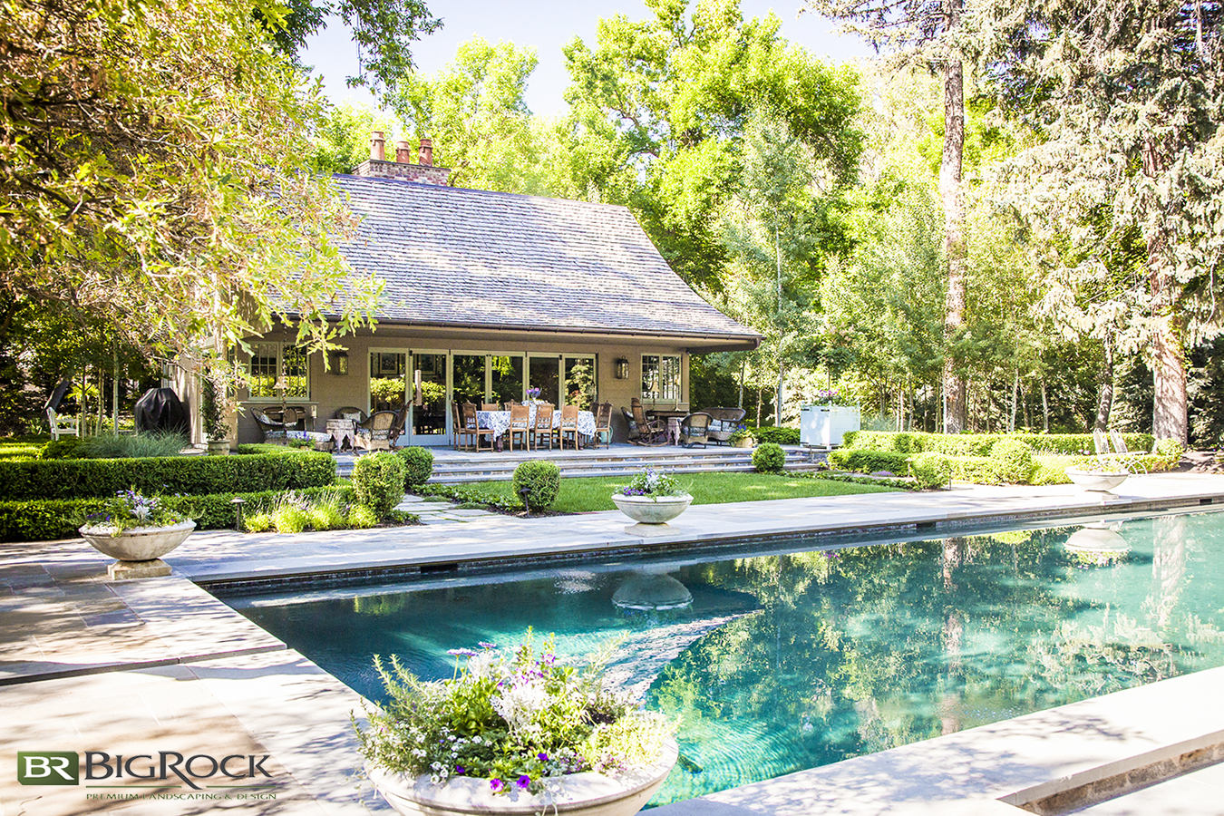 Add interest and beauty around your pool with touches of landscaping with flower pots, greenery and grasses.