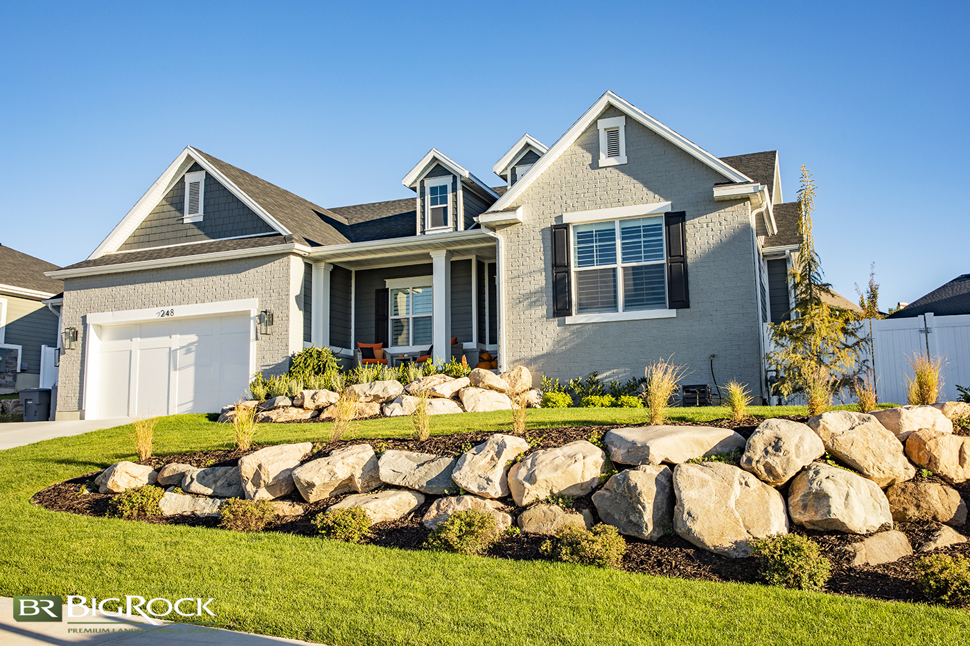 Create design interest throughout your home landscape with a natural stone rock wall design.