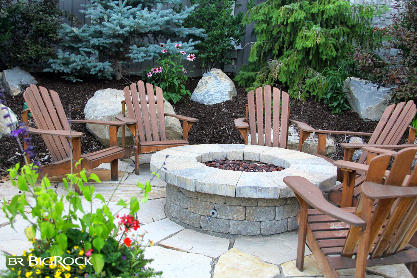 A raised gas fire pit is the perfect outdoor living feature for your residential backyard landscaping. Built with pavers or customized to match your landscape design, Big Rock Landscaping can create any fire pit installation.