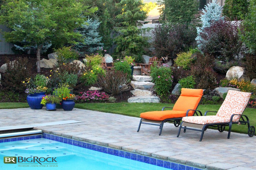 While the pool pavers and grassy areas give this yard dimension, they also create the perfect contrast to the crowded garden beds that separate the pool area from the upper sitting area