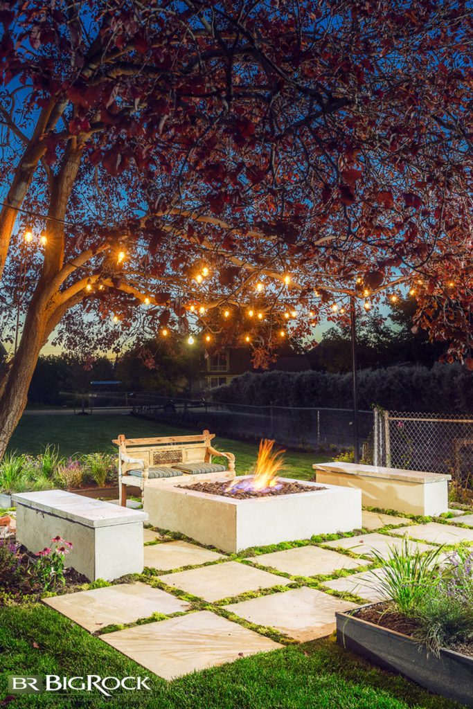 Installing permanent lighting works beautifully in many instances, particularly when your outdoor fireplace is close to a structure, but we love the look of more free-flowing temporary lighting, too.