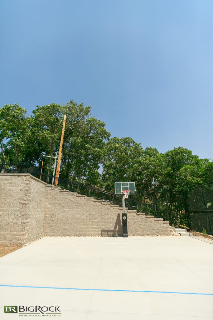 We put the sport court at the bottom of the yard, for multiple reasons