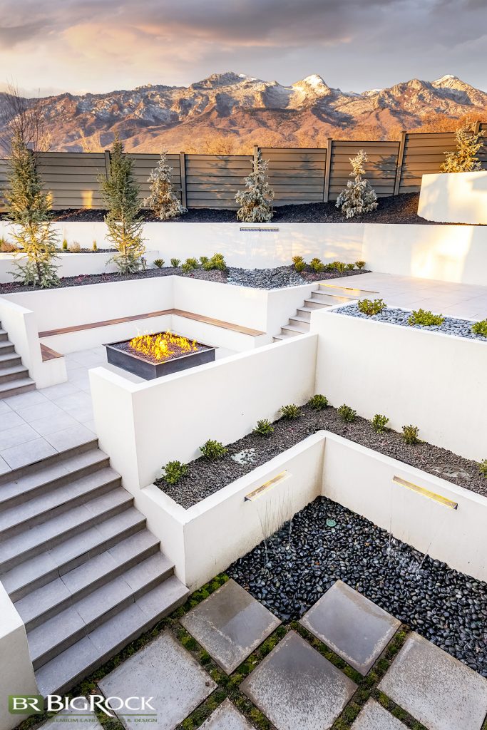Hillside backyards are a fantastic opportunity to create outdoor “rooms” that allow us to include a variety of outdoor elements like firepaces, seating, water features, and creative lighting solutions that give this modern home interest and depth