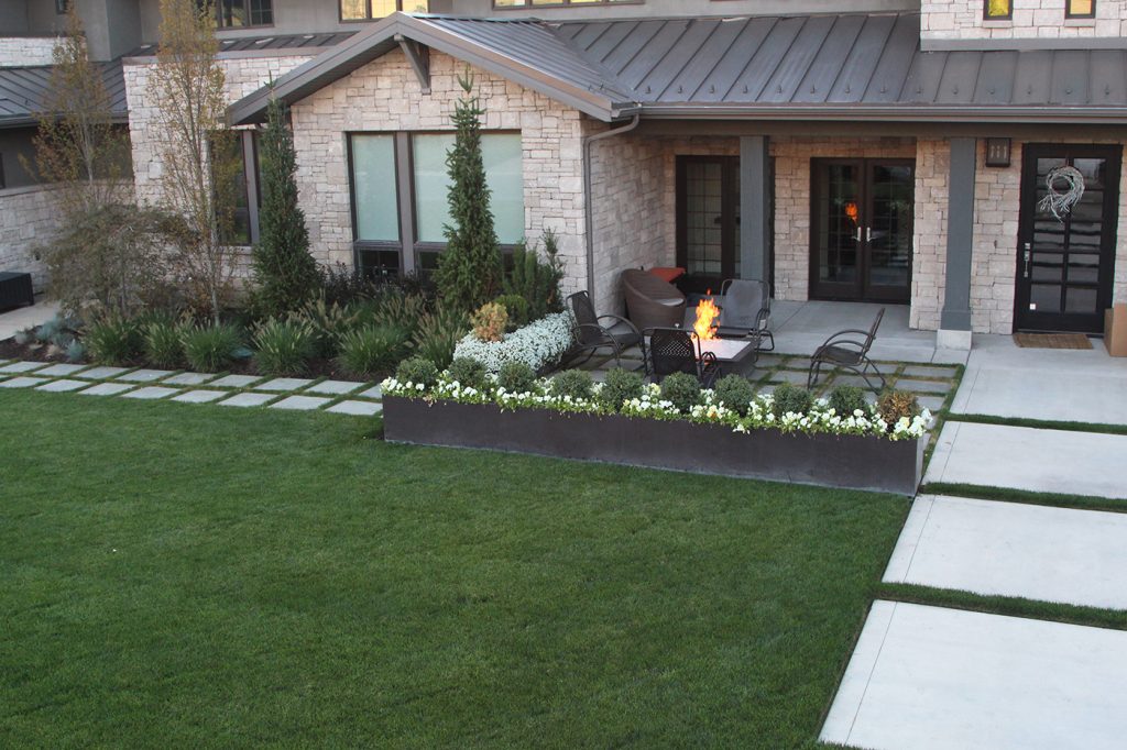 For a more natural look you could add large stone pavers, either to match or compliment the stones in the side of your home.