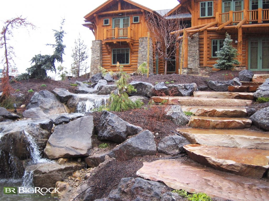 Water features are always a big hit, and this one was inspired by the log-cabin exterior of the home. It is carefully designed to give the appearance of a natural stream outdoors.