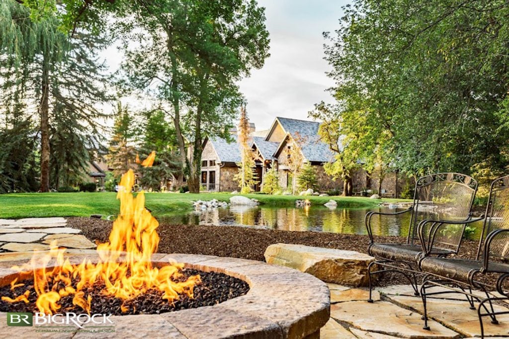 This backyard oasis does a perfect job of surrounding the pond with natural elements like flagstone, mulch, and boulders to complete a natural look of tranquility and peace