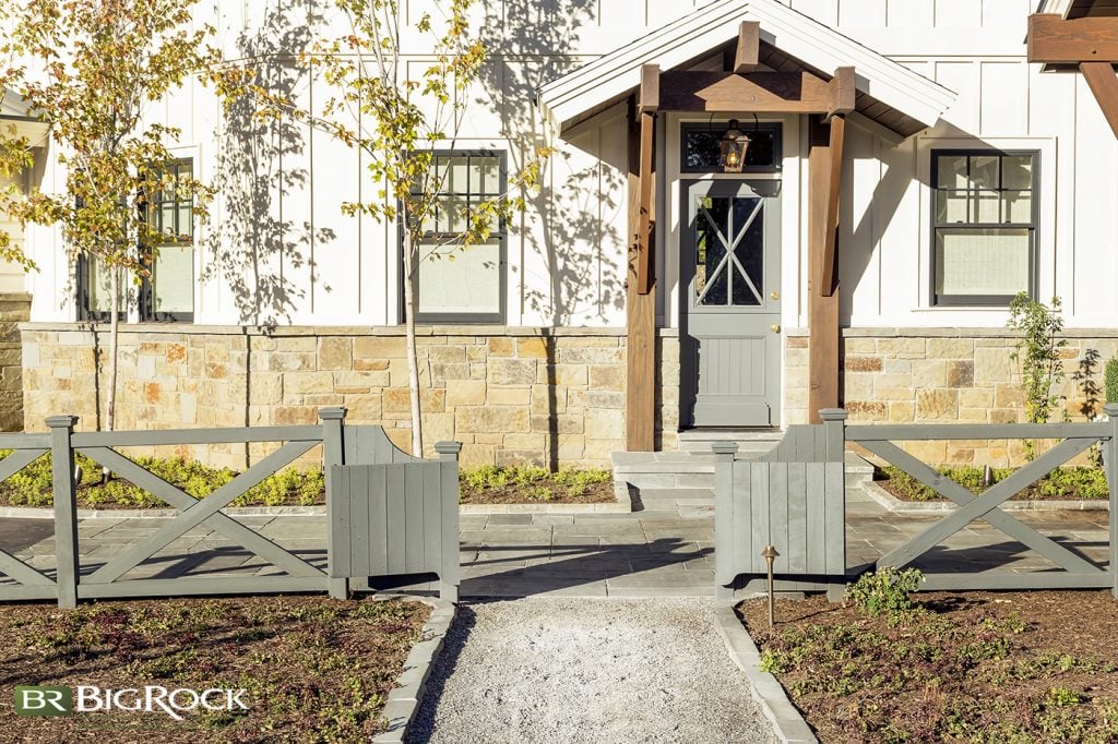 Farmhouse landscaping is a relaxed, or informal landscaping style. It often features natural elements like stone walls and walkways, utilizes native plants, and has lots of flowers, though these are typically in muted colors