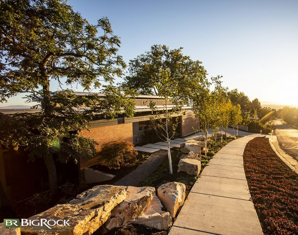 Built into the hill, this home uses its topography, natural materials, and native plants to create an inviting front yard entry.