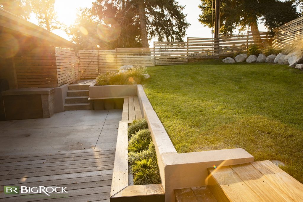 The retaining wall and decking reduce the grassy area in this backyard, but they don’t cut down on the fun.