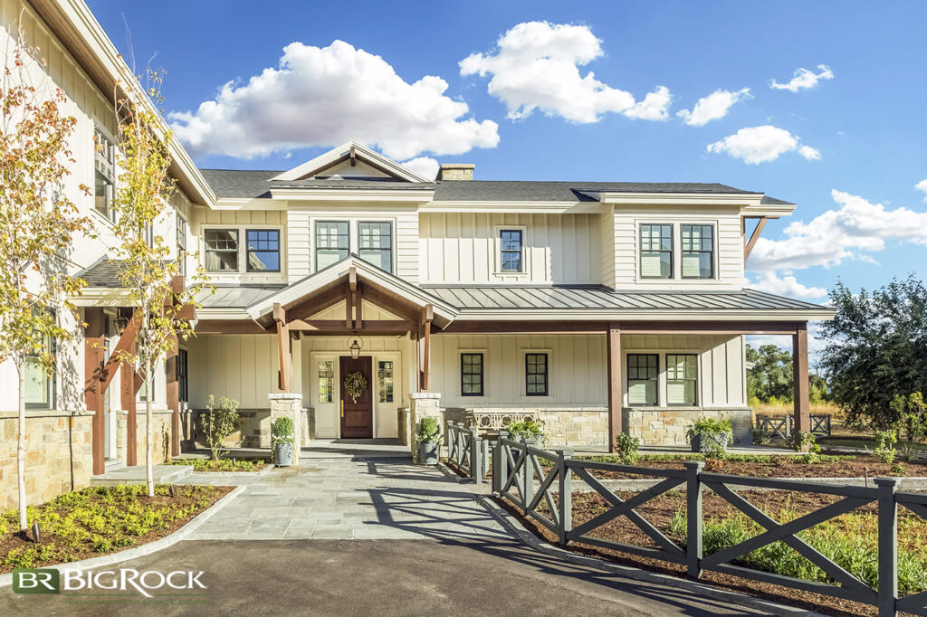 Hardscape and decorative elements guide visitors to the home’s entrance, which is accented by container plants. We also love the use of trees and groundcover, which help create a cottage-like appeal.