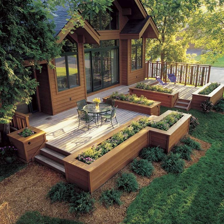 This deck feels like an extension of your living room. Notice how the designer has utilized planted pots and living walls to create a cozy, organic space