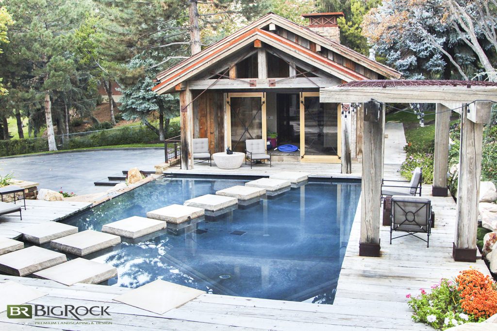 Pool decking comes in concrete, natural stone, pavers, unglazed tile, and wood. We love the versatility of concrete.