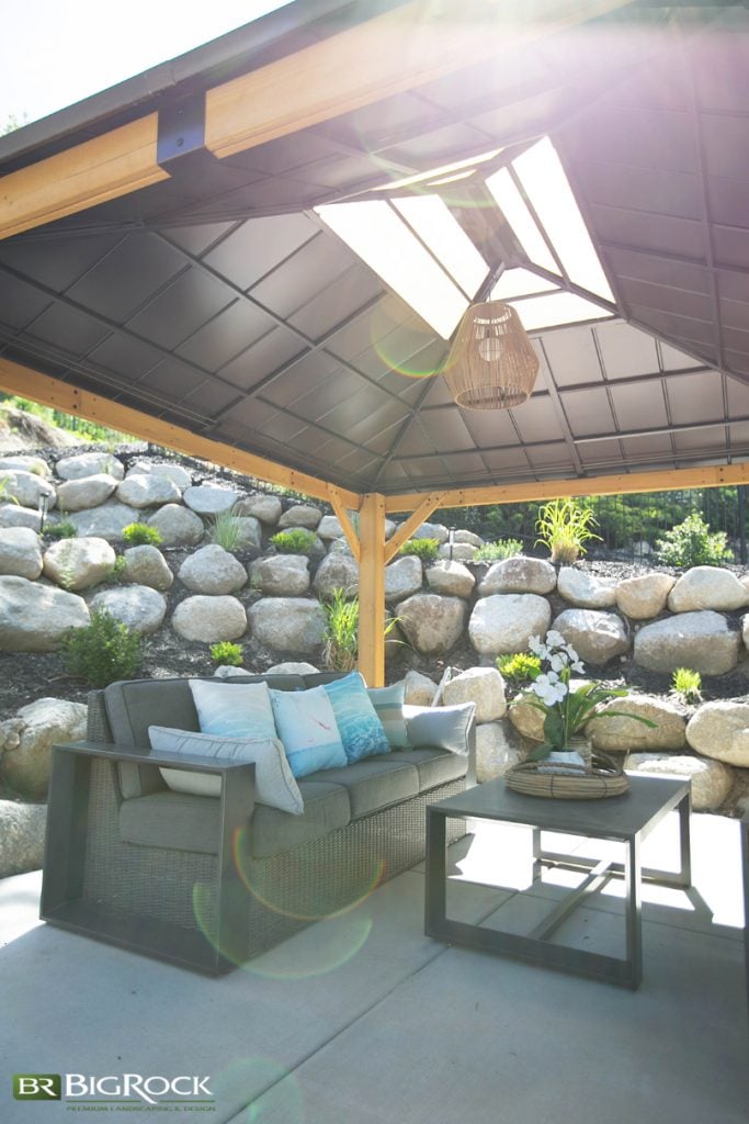 Large rocks are most often seen used in retaining walls, but they also work well when used to add levels and dimension to a yard or to separate one area from another