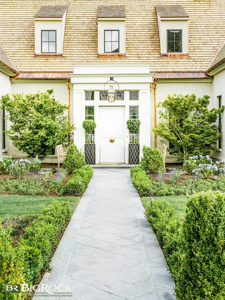 Trees can also help make a real statement of your front entry. Here they guide the eye, subtly bringing focus and attention to a door that deserves every gaze it gets. Not only does that increase the appeal of arriving home each day, but those trees boast a welcoming curb appeal, boosting resale value should you ever wish to leave.