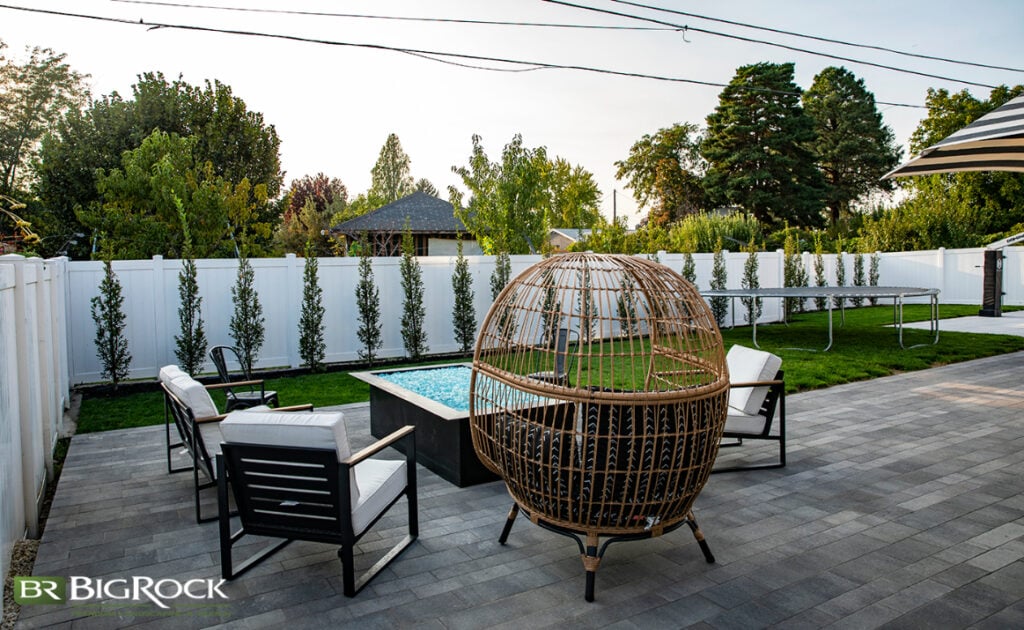 Choose the right size for your water feature or fire pit- that doesn’t necessarily mean making it small. Sometimes, these can act as focal points and add to the cohesiveness of your space like the landscaping elements featured here.