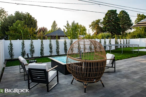 Choose the right size for your water feature or fire pit- that doesn’t necessarily mean making it small. Sometimes, these can act as focal points and add to the cohesiveness of your space like the landscaping elements featured here.