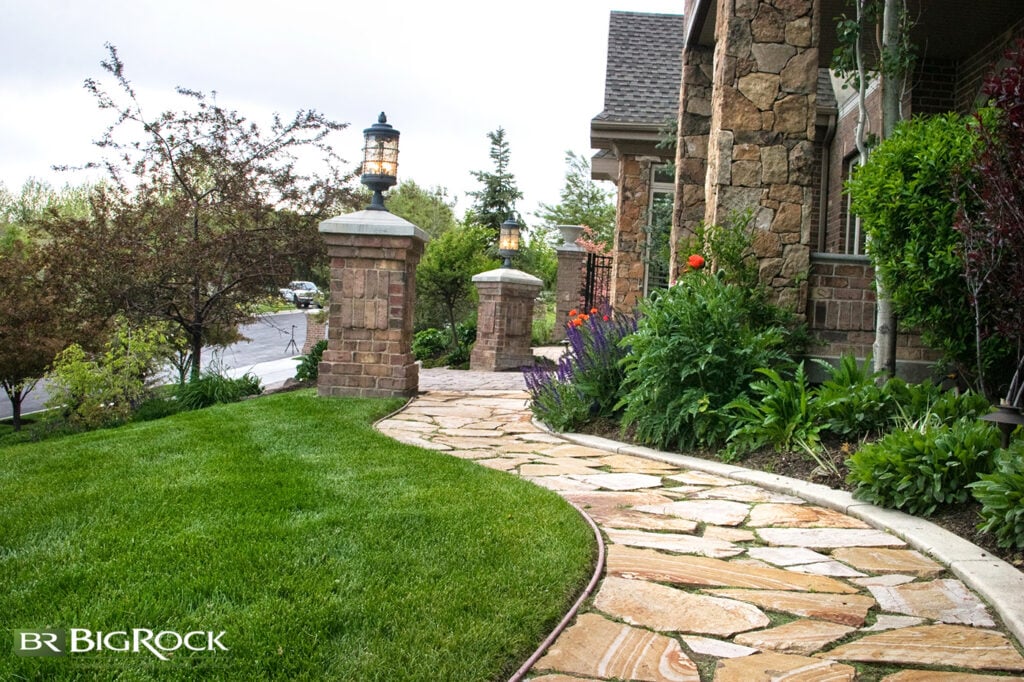 Beautiful hardscaped walkway in luxury front yard.