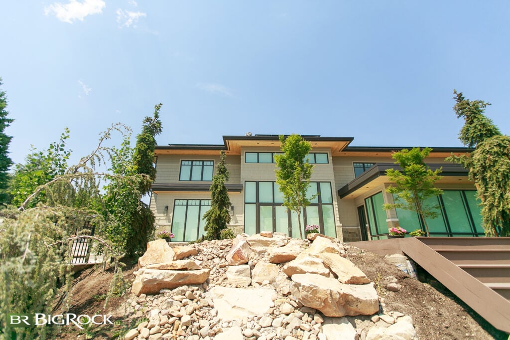 Boulder rock walls are a prime way to create a sloped front or backyard. In addition to a natural aesthetic that complements Utah's landscape design beautifully, using boulder rocks to create retaining walls for sloped yards is a fantastic way to prevent soil erosion.